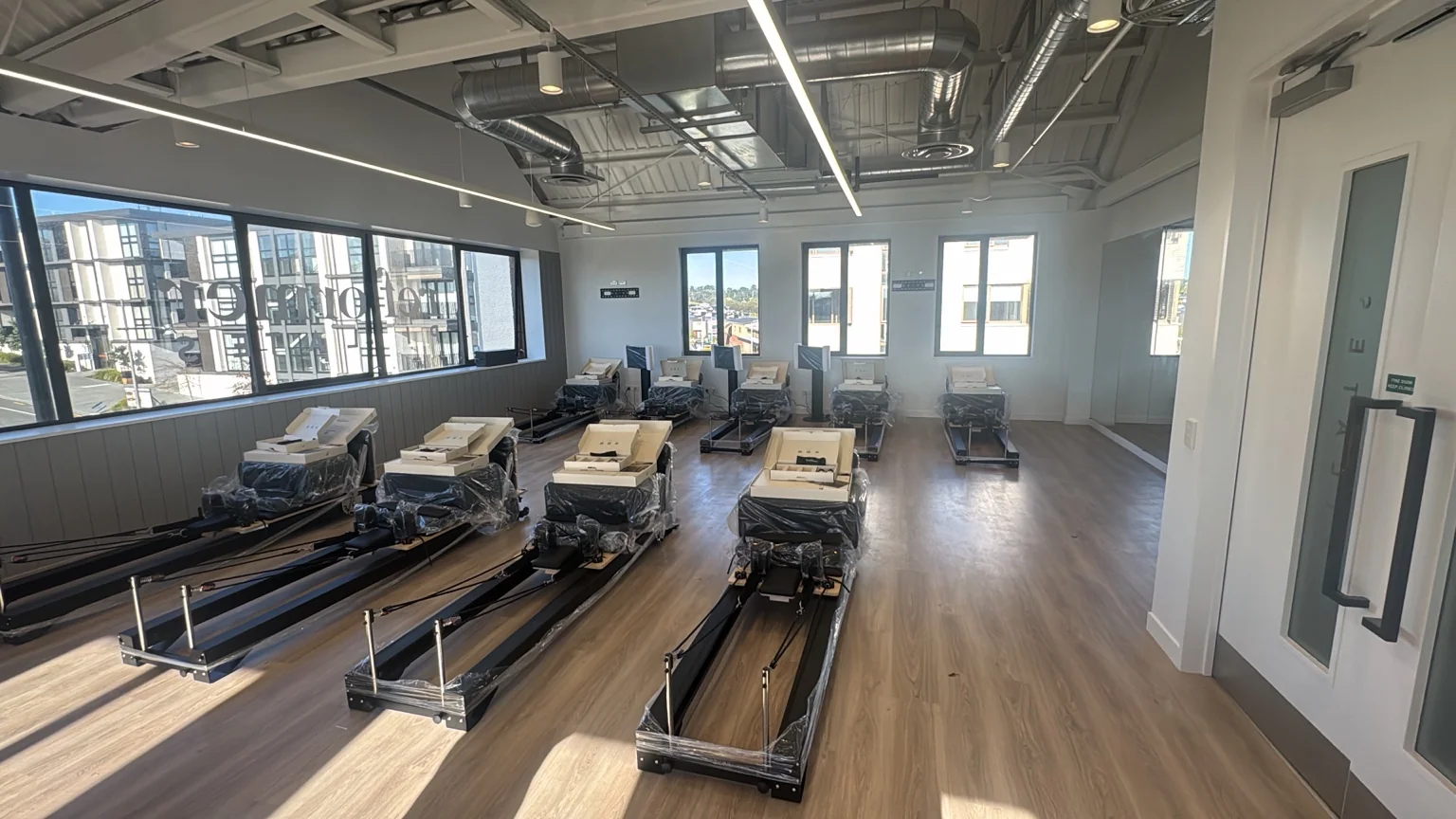 Additional view across the Reformer Pilates equipment and painted interior