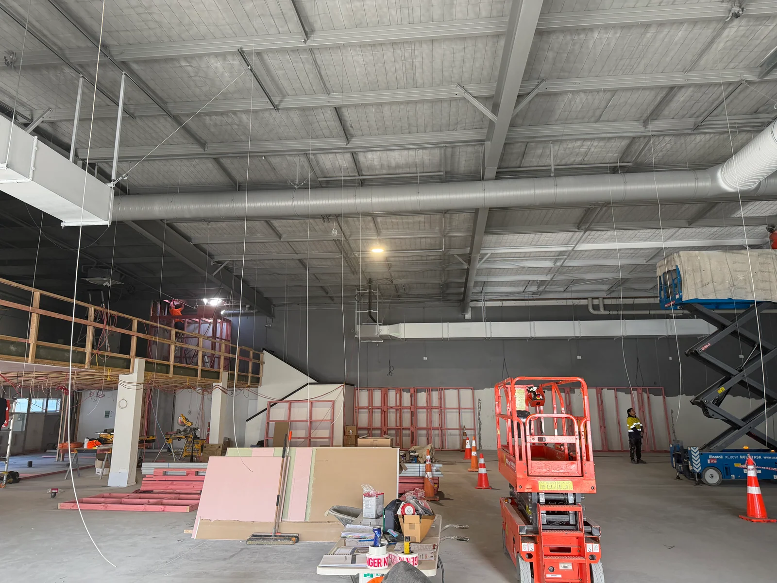 Wide view of the gym interior during ceiling and fit-out work
