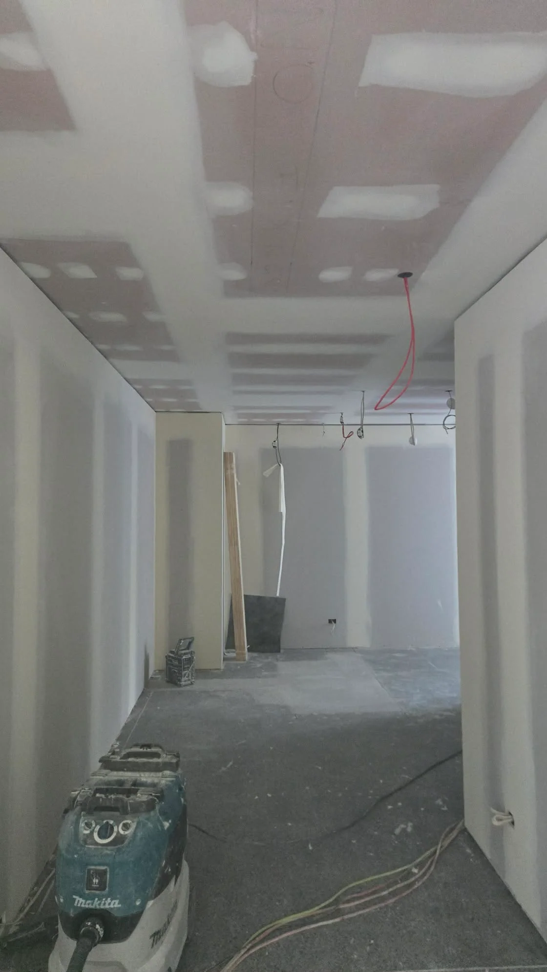 Plastering in progress: stopped wall and ceiling joints before painting